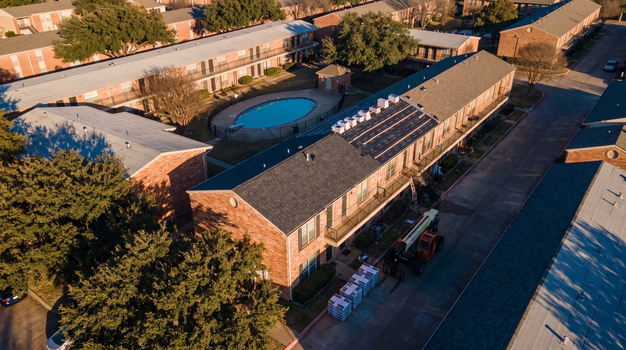 Two-story brick townhome community mid re-roof (illustration)
